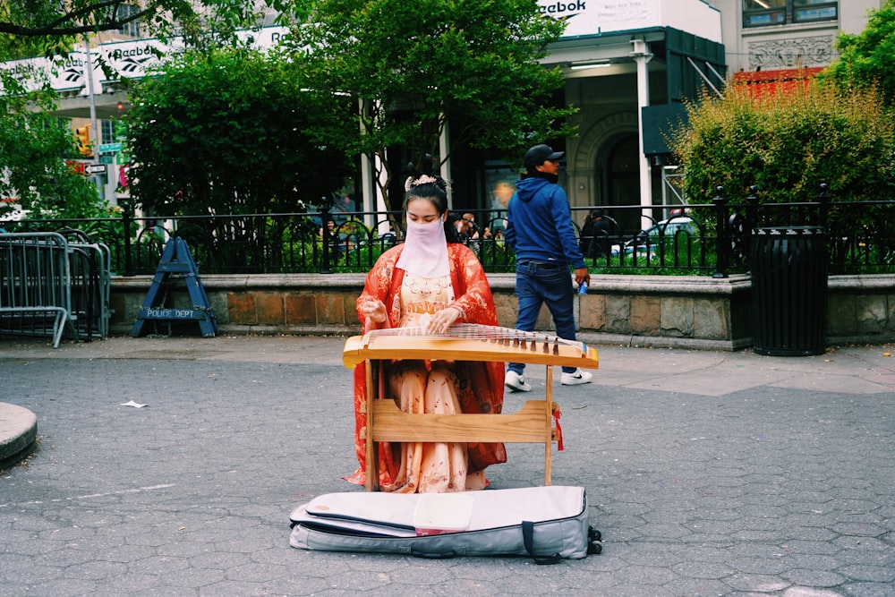 a woman in a kimono playing a musical instrument