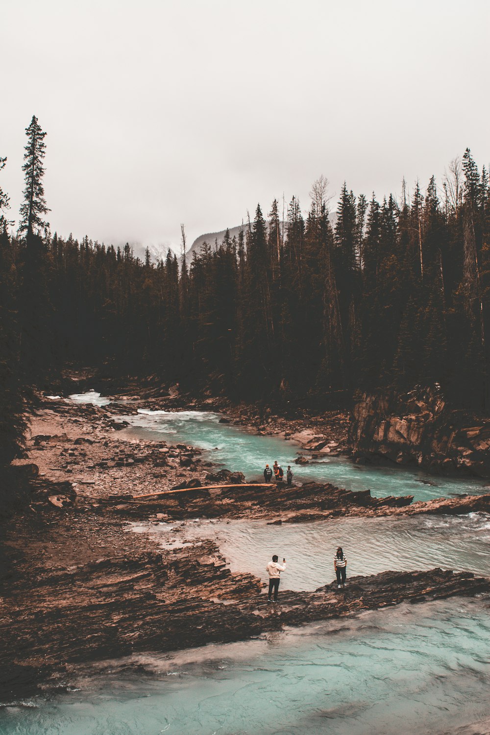 a group of people standing on top of a river