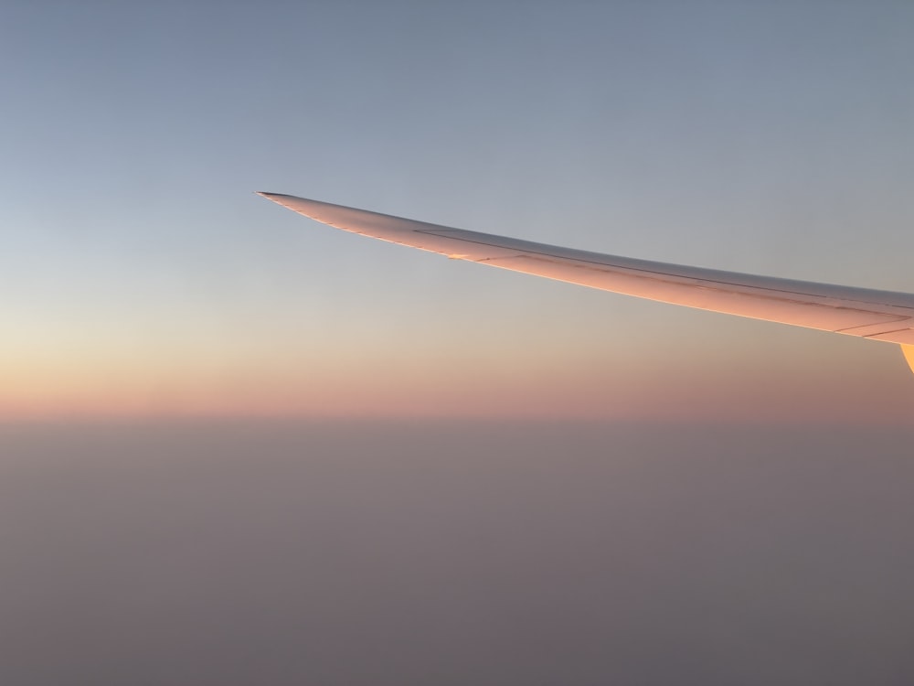 a view of the wing of an airplane in the sky