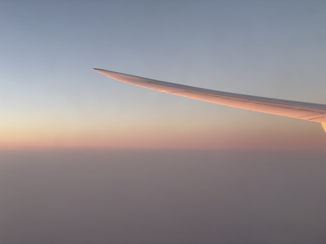 a view of the wing of an airplane in the sky, 