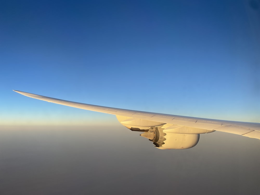 the wing of an airplane flying in the sky