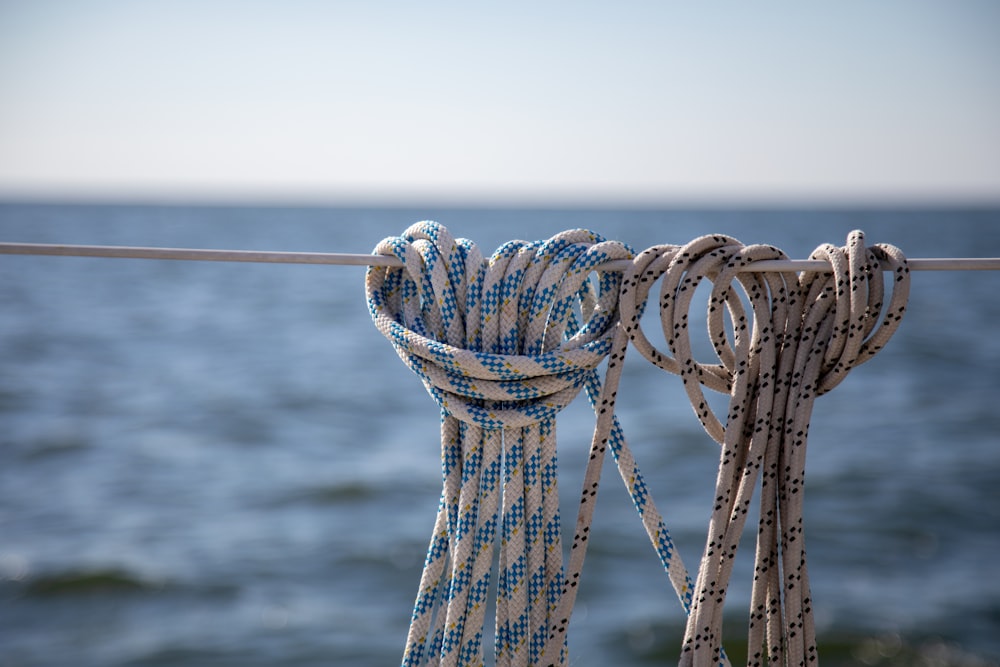 a close up of a rope with a body of water in the background