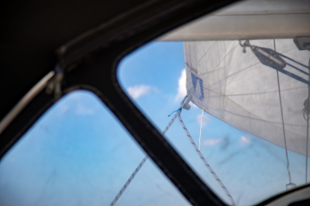 a view of a sailboat through the window of a vehicle