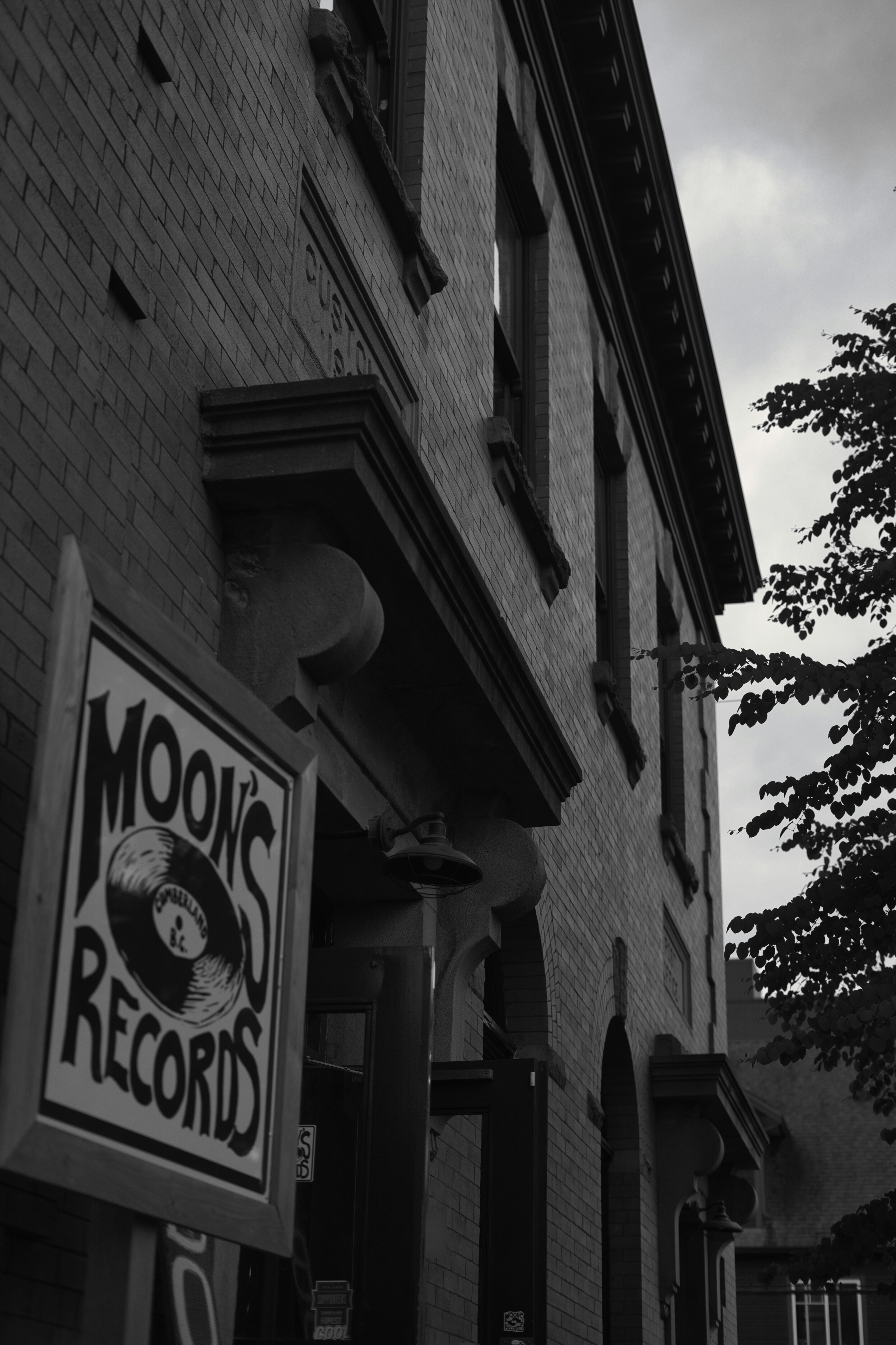 a black and white photo of a sign for a record store