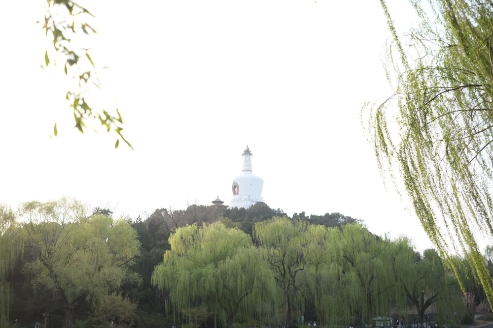 a white building with a bell tower on top of a hill