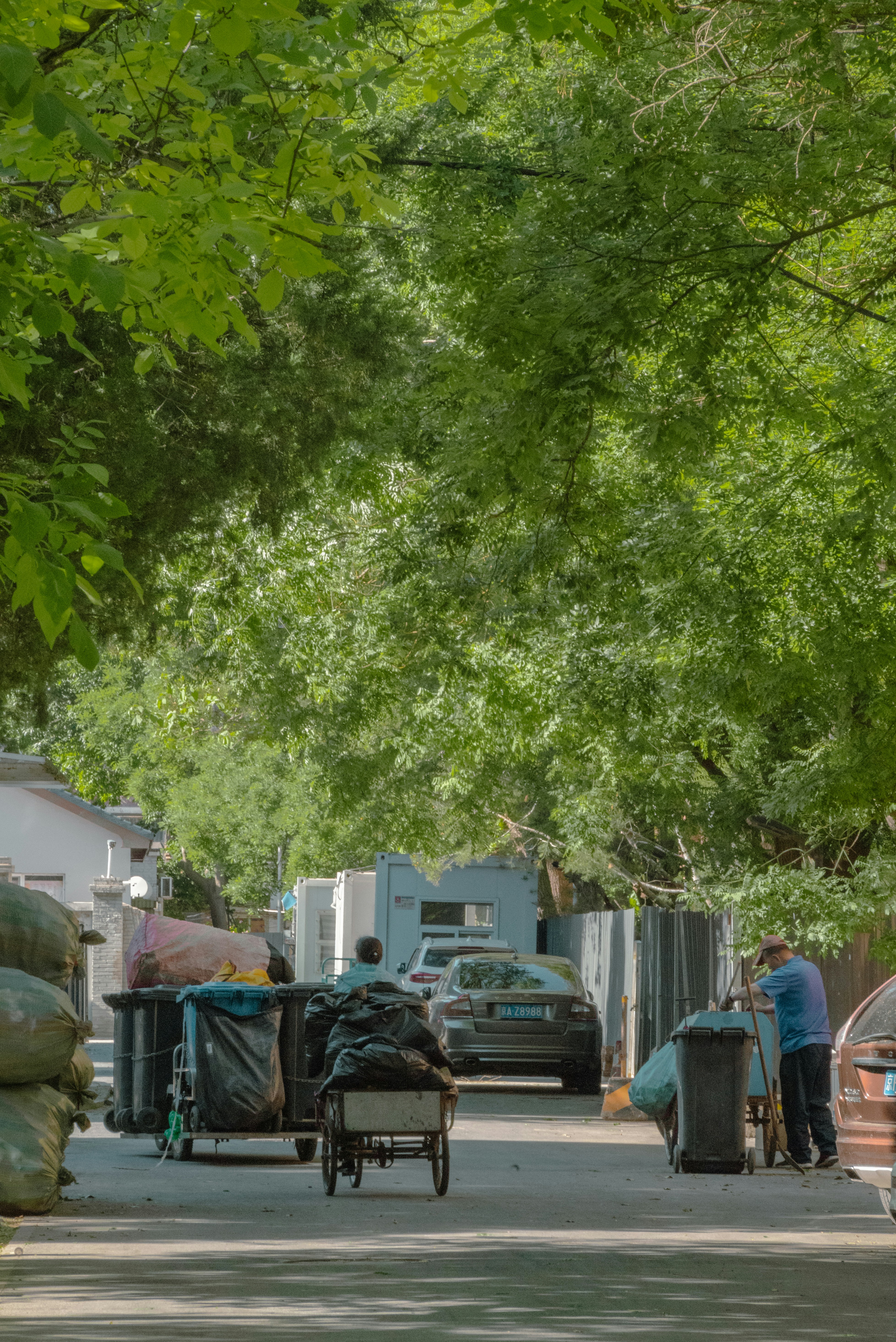 a person pushing a cart down a street