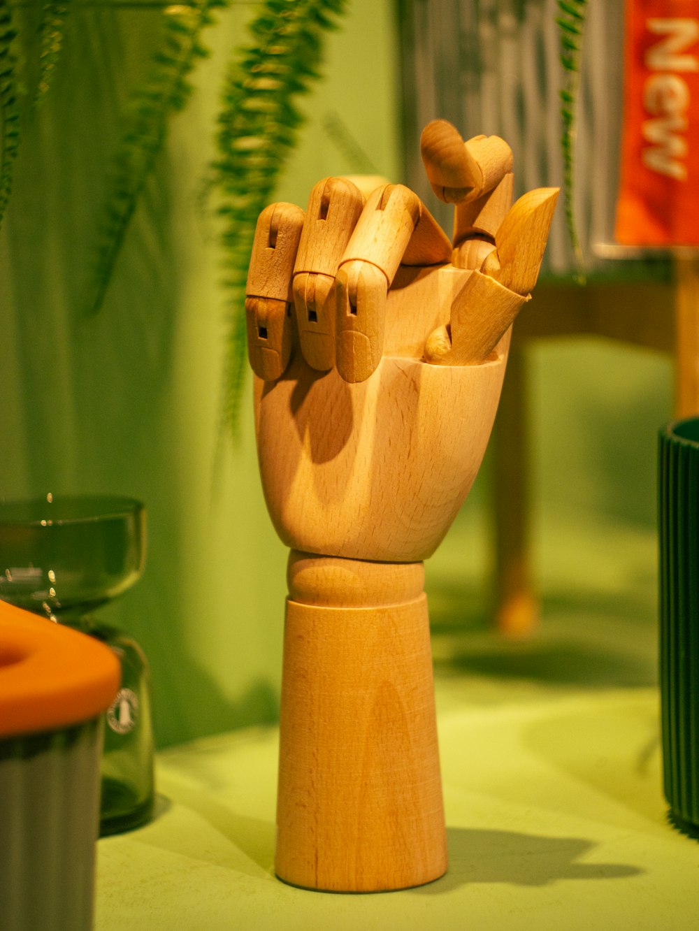 a wooden sculpture of a hand holding something