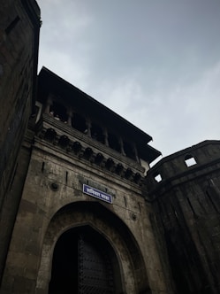 a tall brick building with a blue street sign on it's side