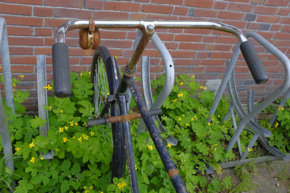 an old bicycle is leaning against a brick wall