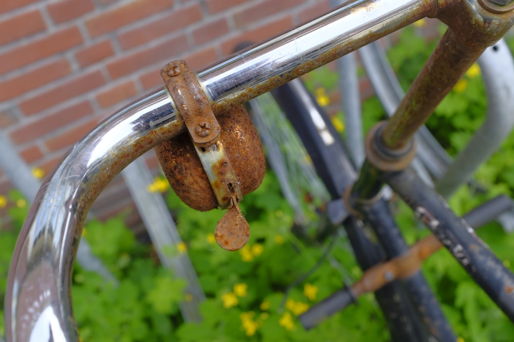 a rusted metal railing with a brick wall in the background