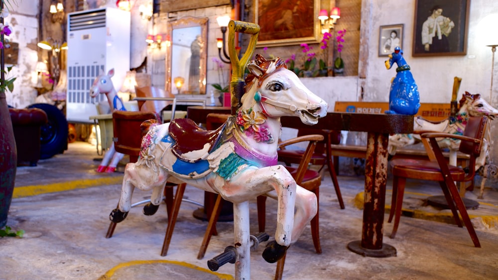 a carousel horse sitting on top of a wooden table