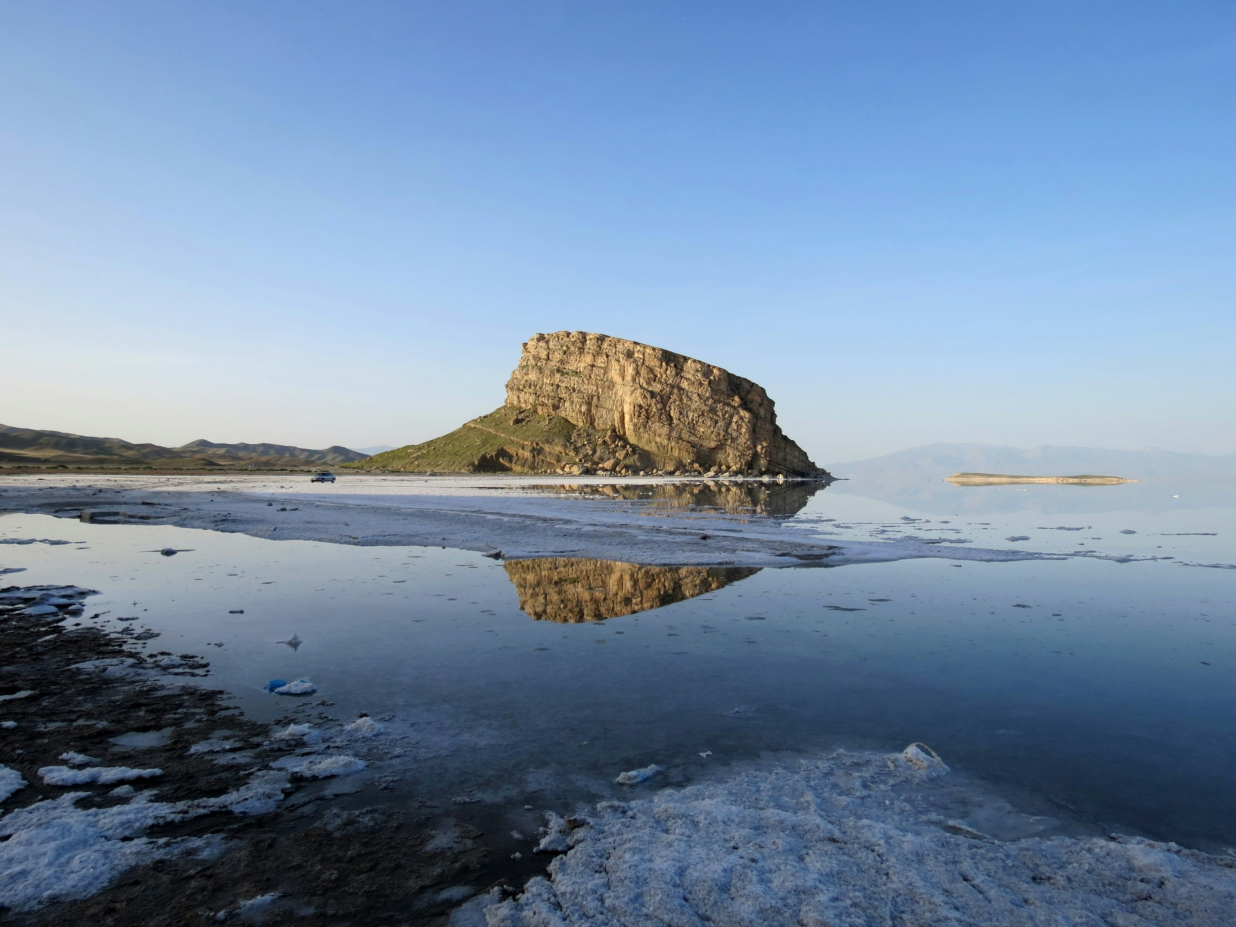 a large rock in the middle of a body of water