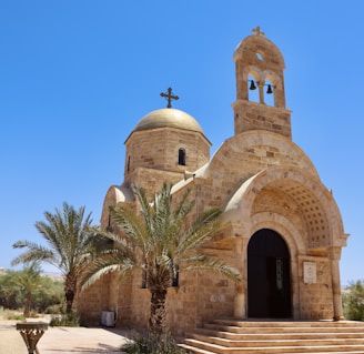 an old church with a palm tree in front of it