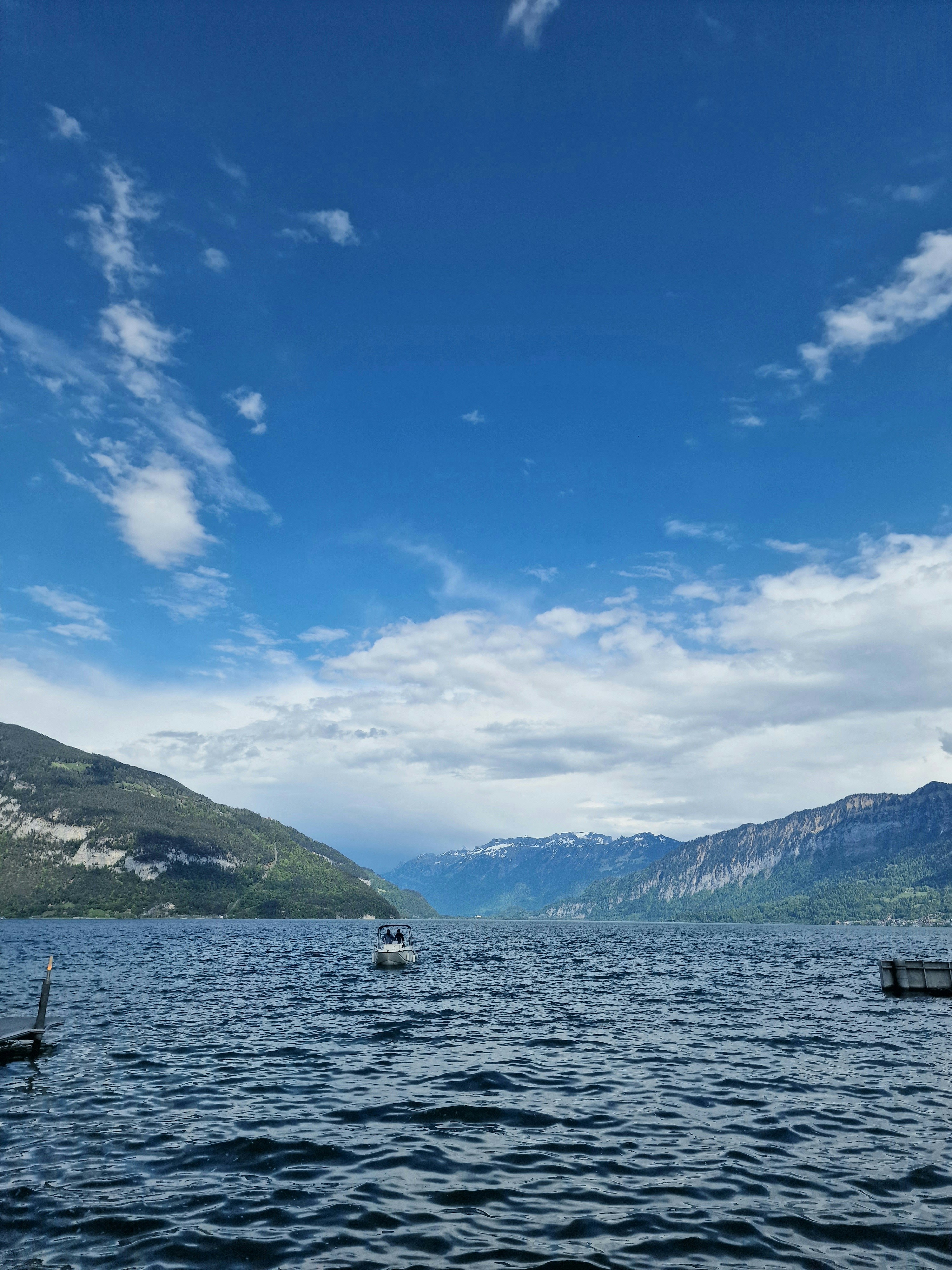 a body of water surrounded by mountains under a blue sky