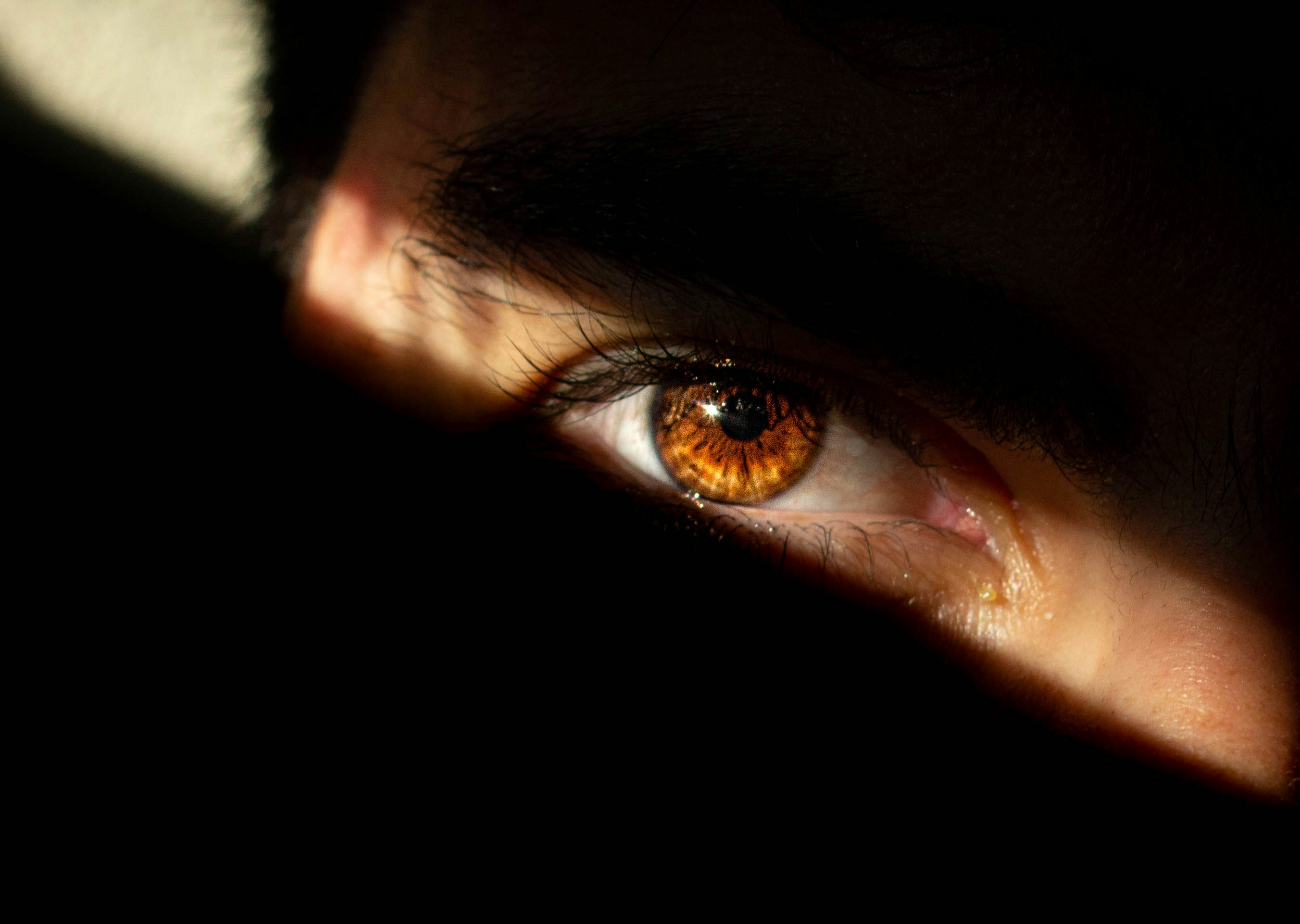 a close up of a person's eye with a shadow