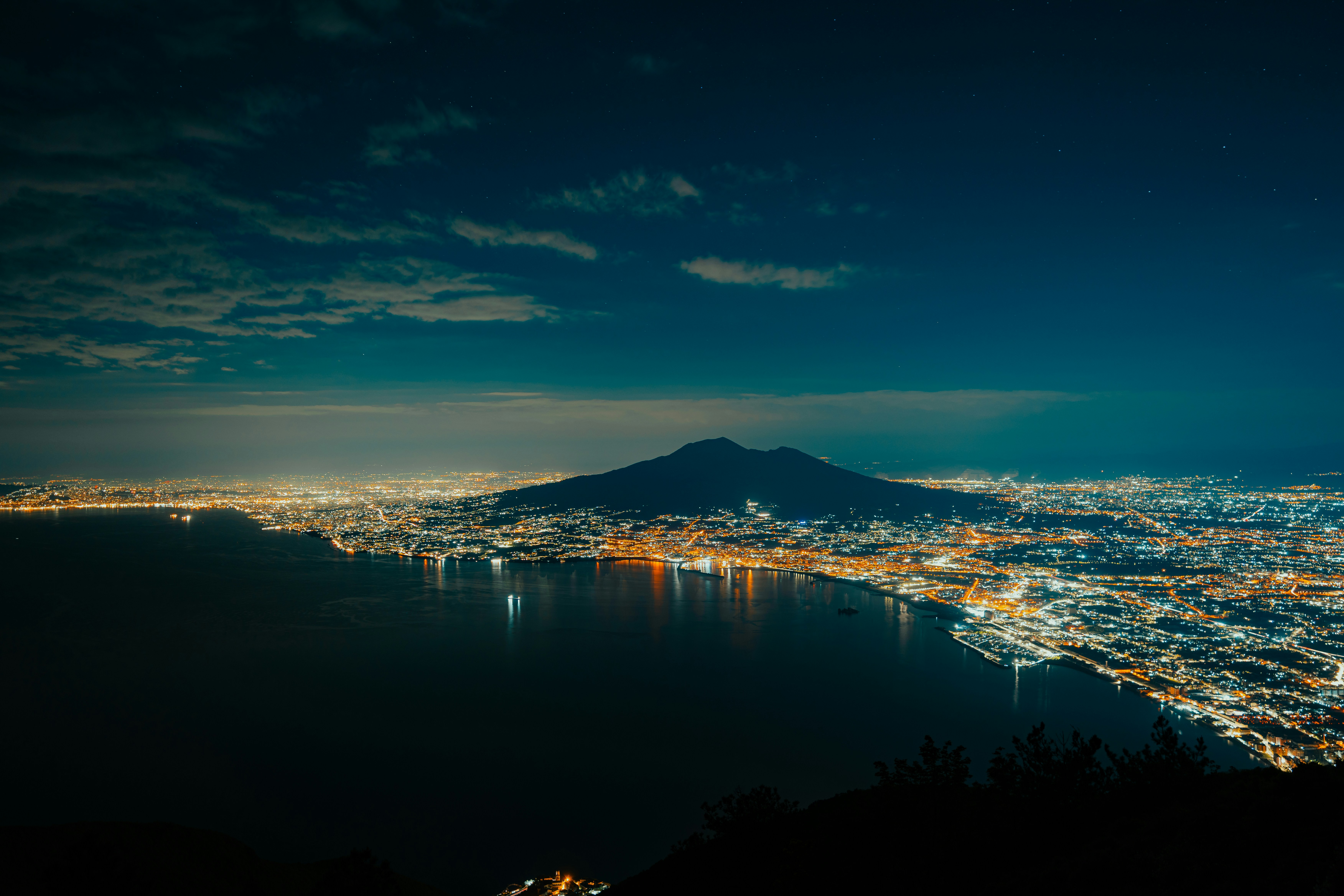 a view of a city at night from a hill