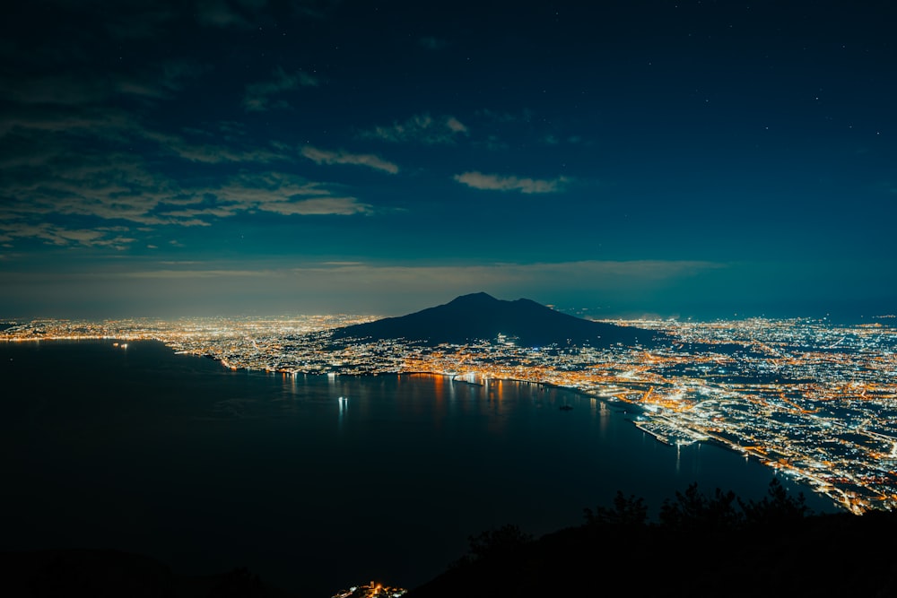 a view of a city at night from a hill