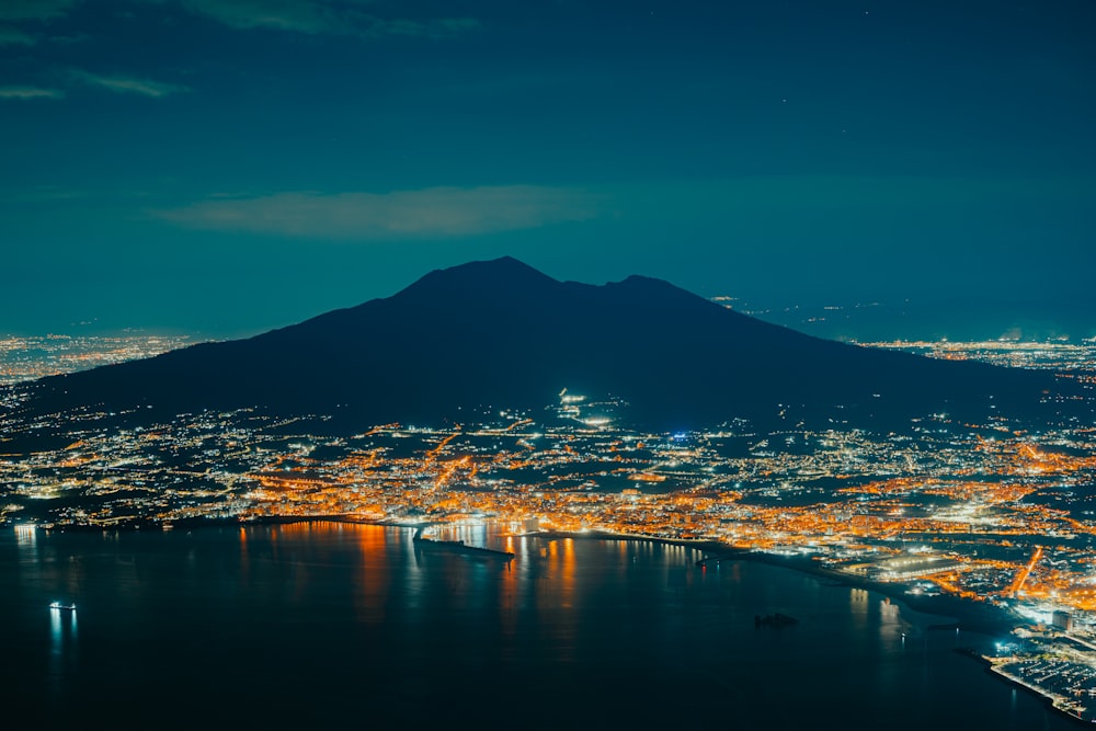 a view of a city and a mountain at night