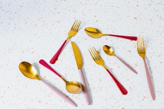 a group of forks and spoons sitting on top of a table