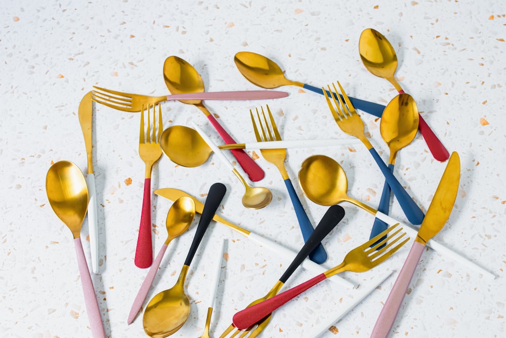a group of forks and spoons on a table