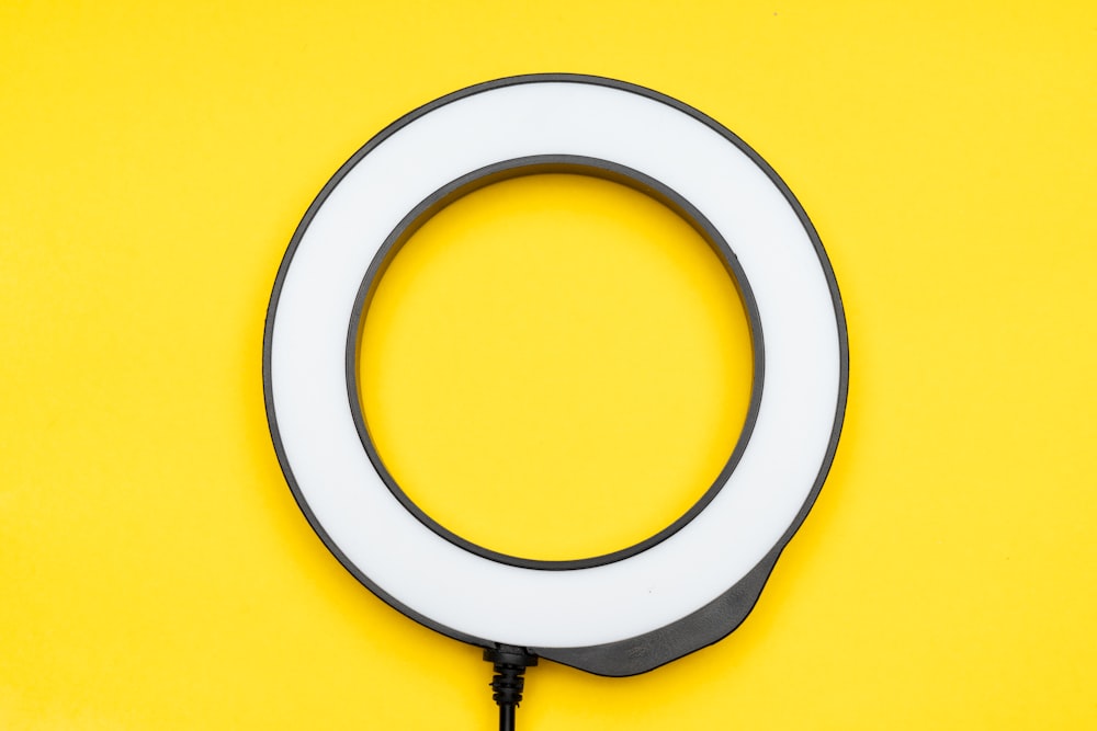 a white ring light on a yellow background