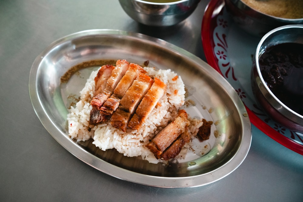 a plate of food with rice and meat on it