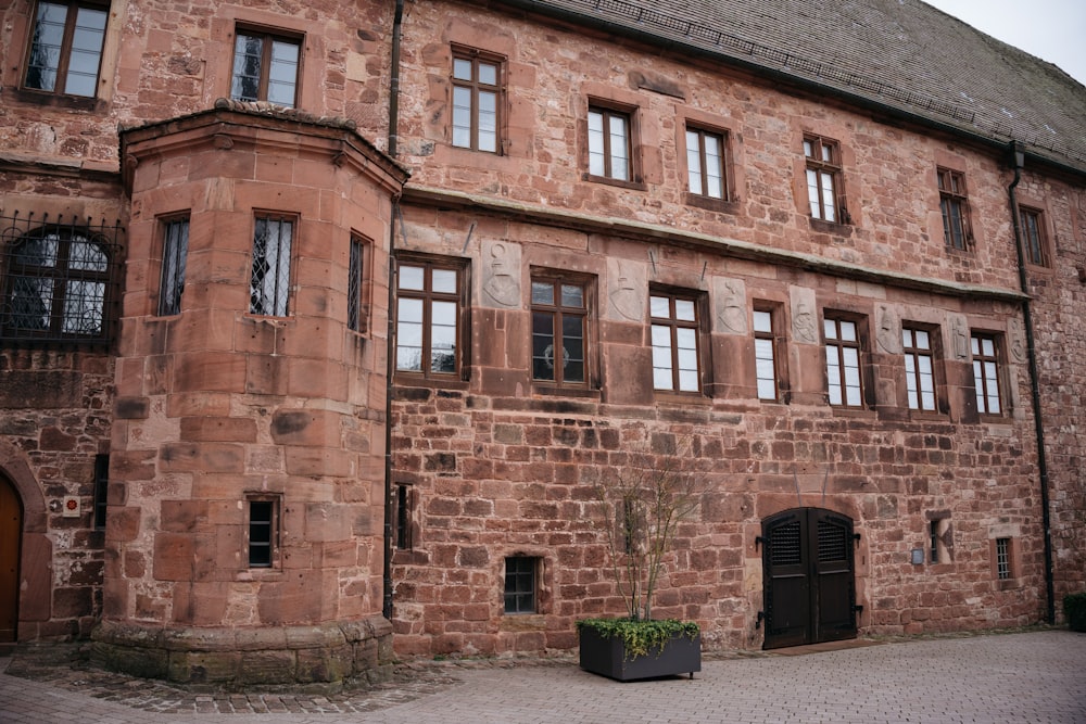 a large brick building with a planter in front of it