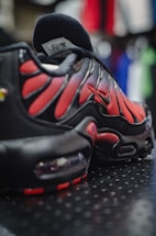 a pair of black and red sneakers on a table