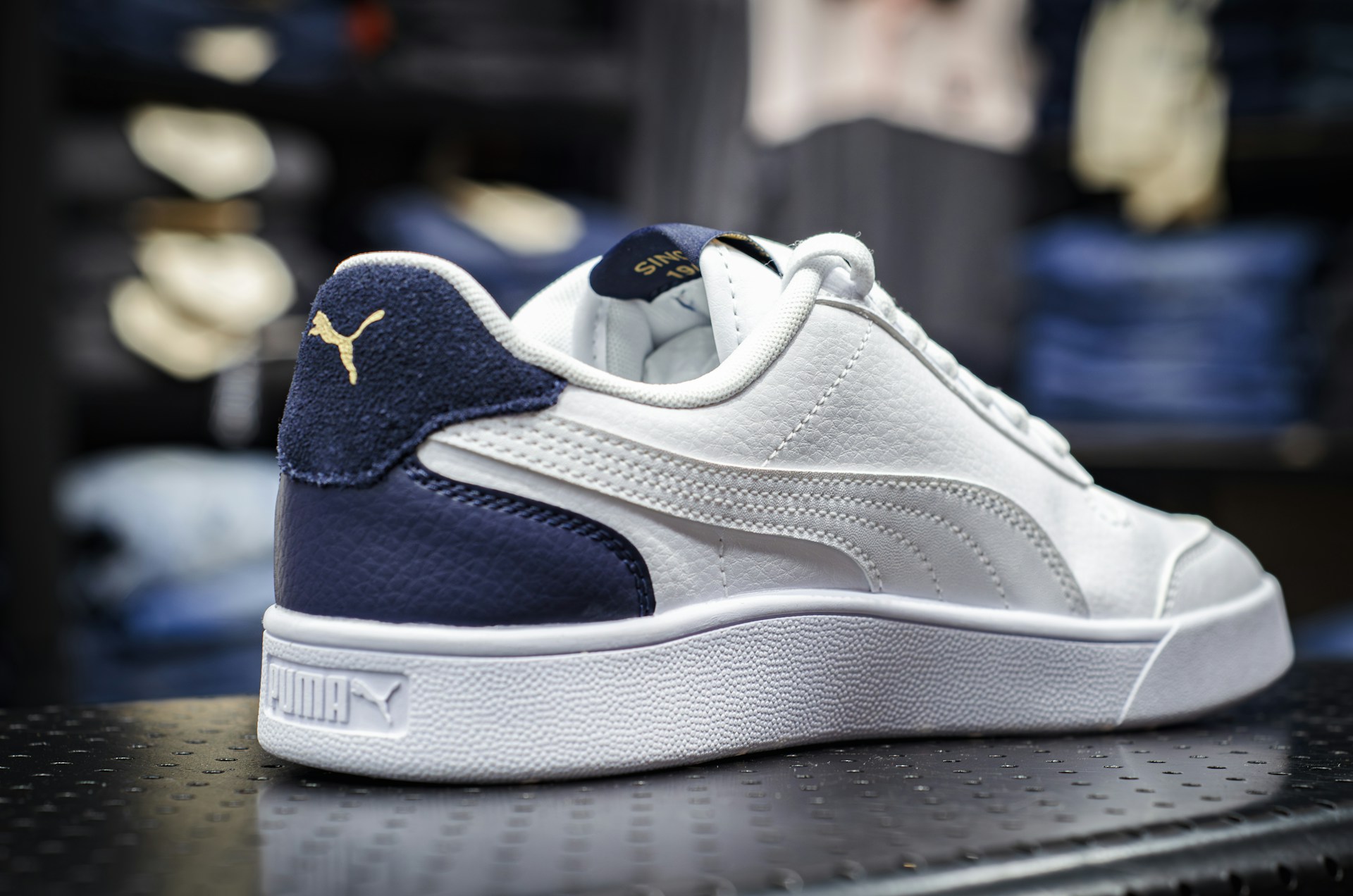 a white and blue sneaker on a shelf