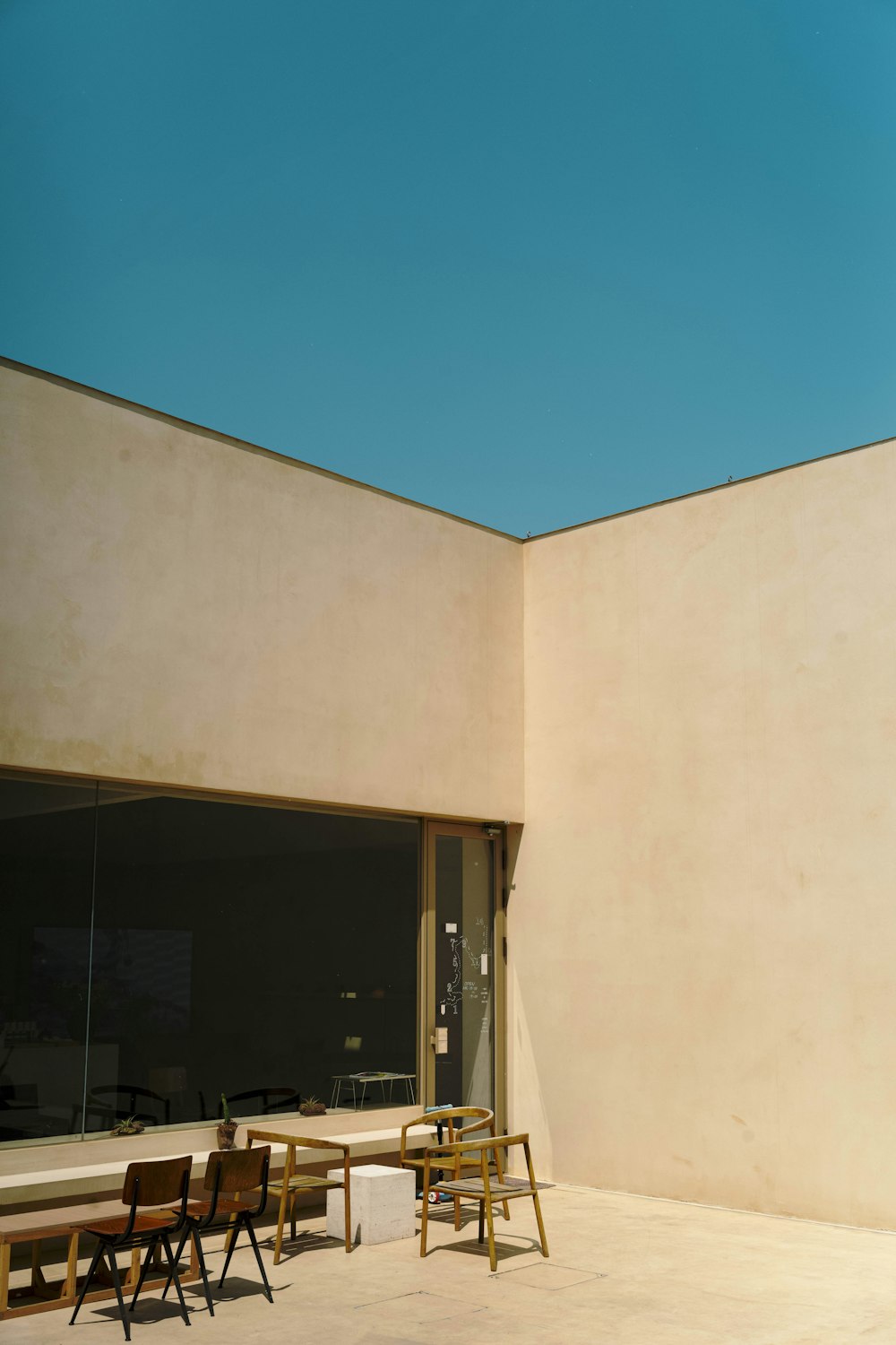 a group of wooden tables sitting next to a building