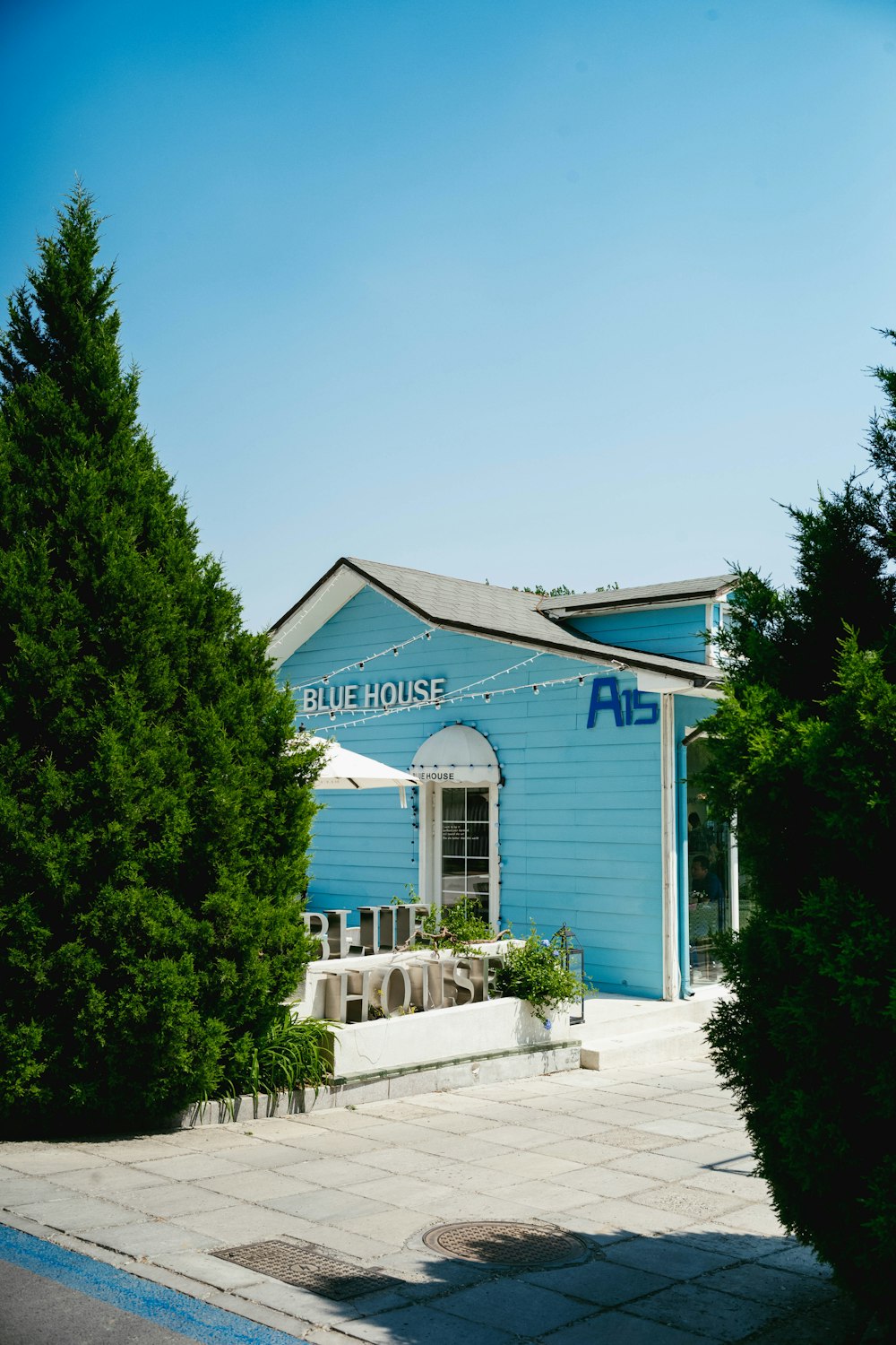 a blue house with a white awning