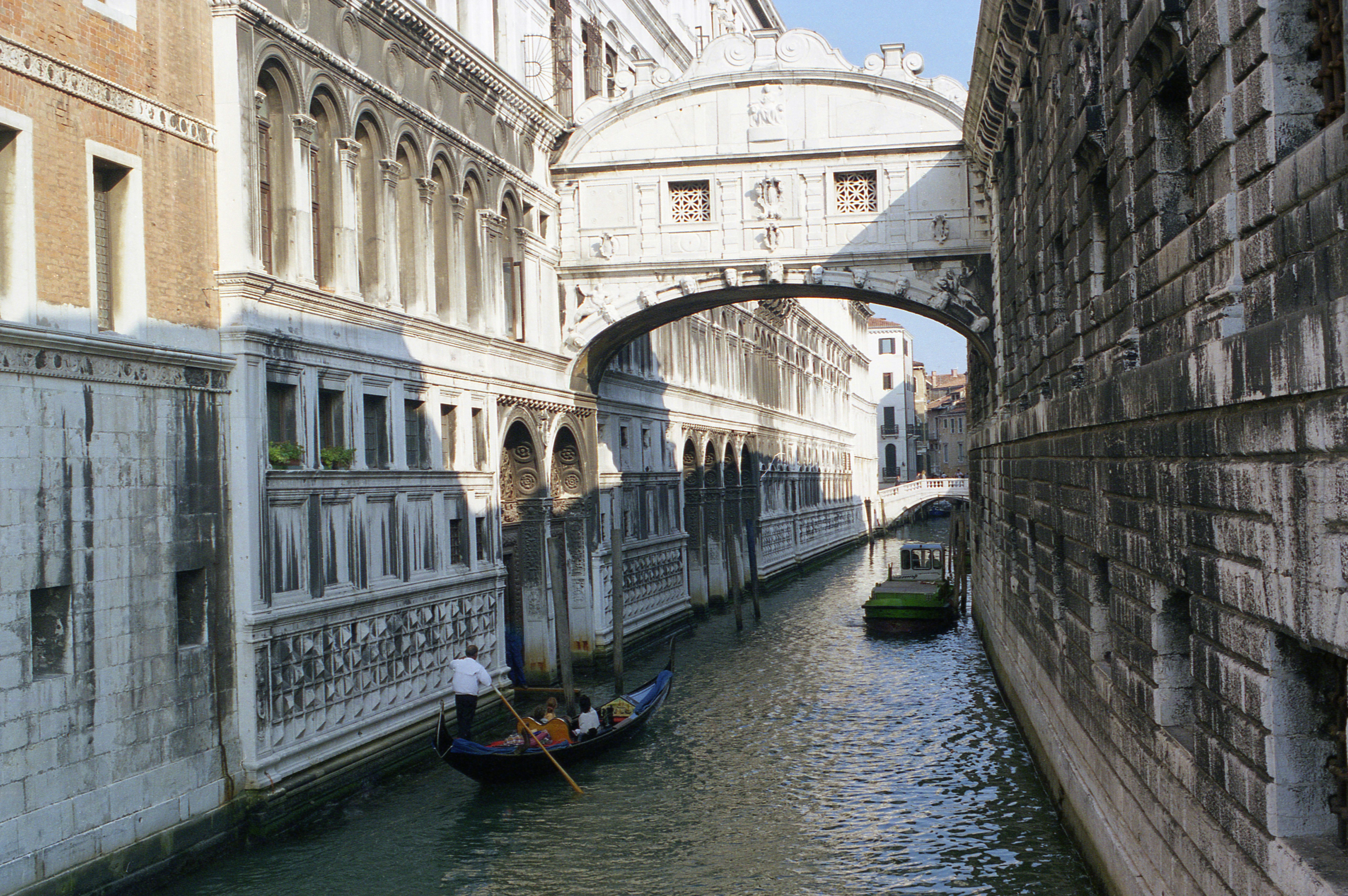 A gondola glides quietly under the Bridge of Sighs in Venice, Italy.
