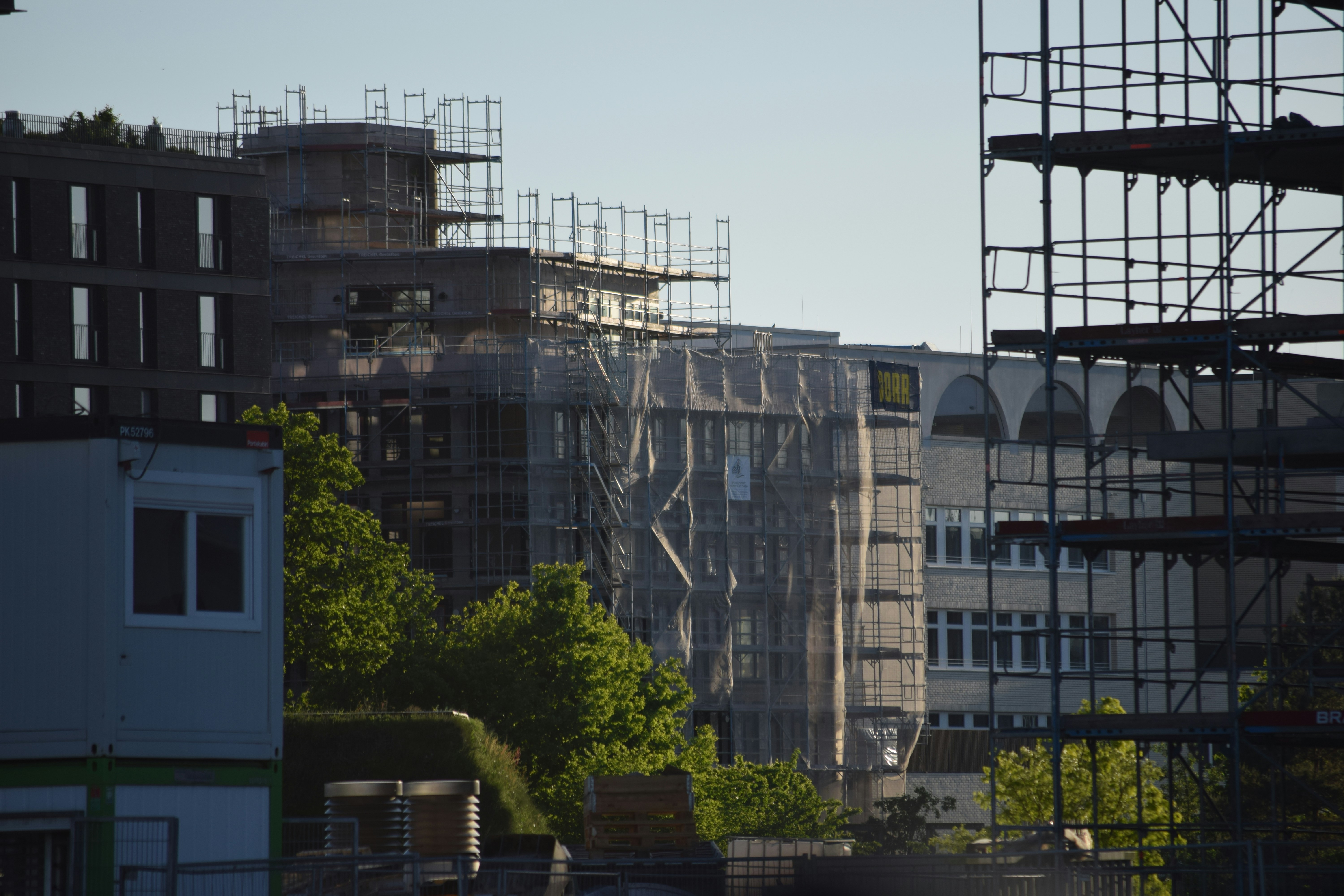 a view of a city with scaffolding on the buildings