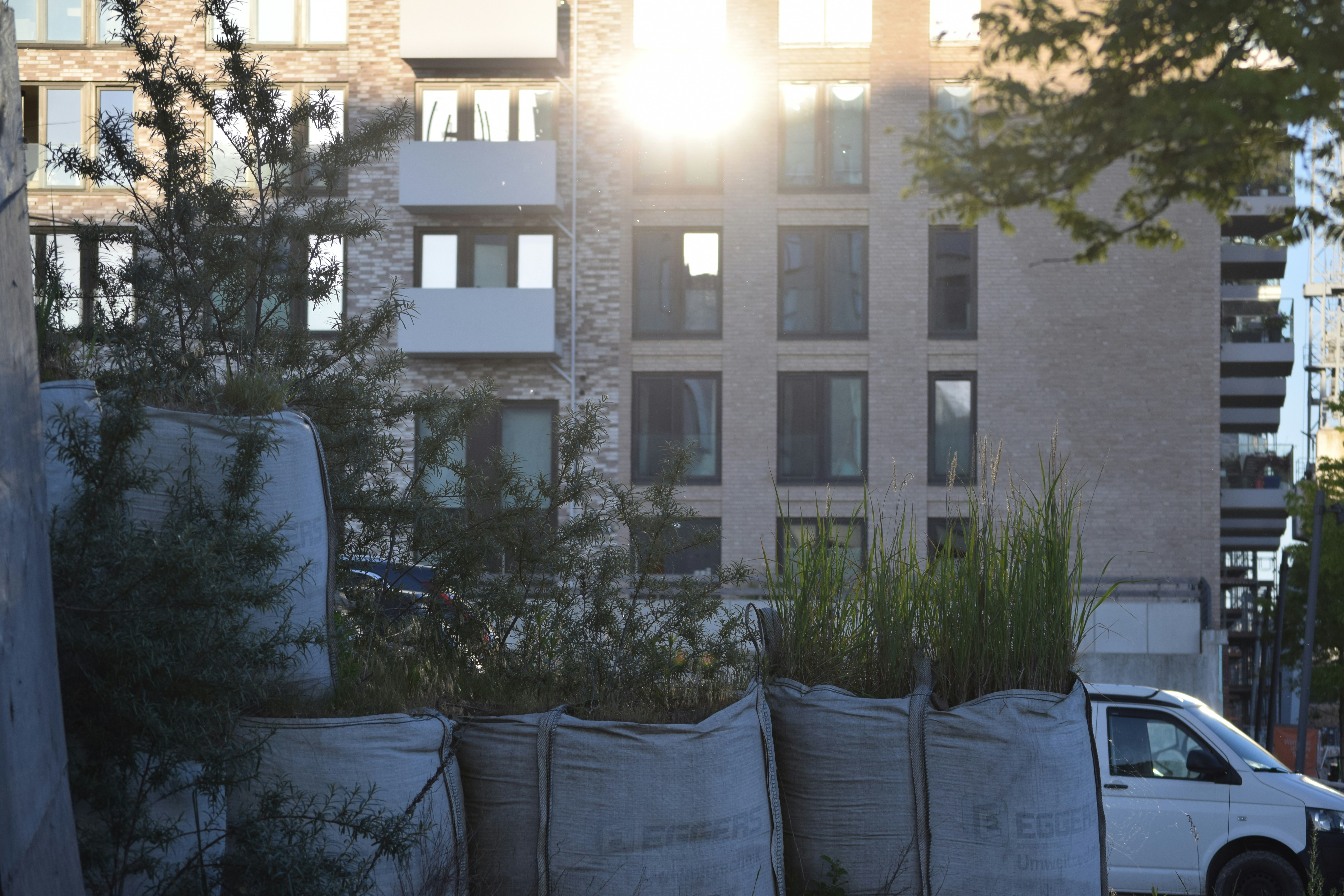 a white truck parked in front of a tall building