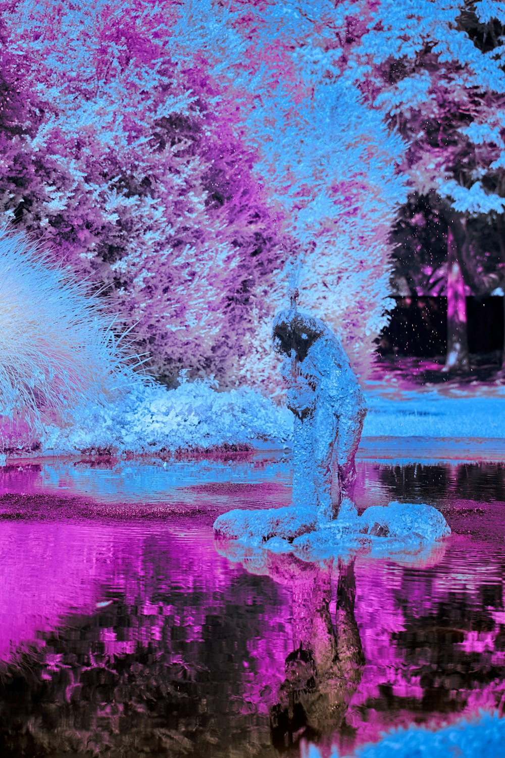 a person standing on a skateboard in front of a pond