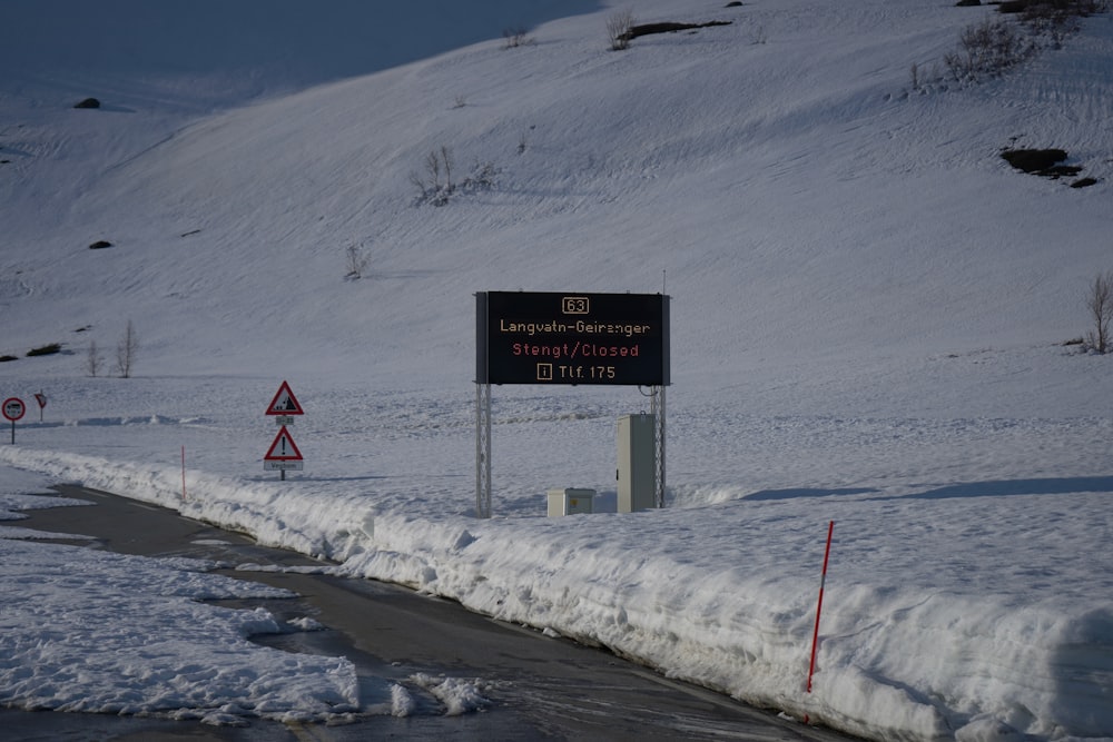 a road sign on a snowy mountain side