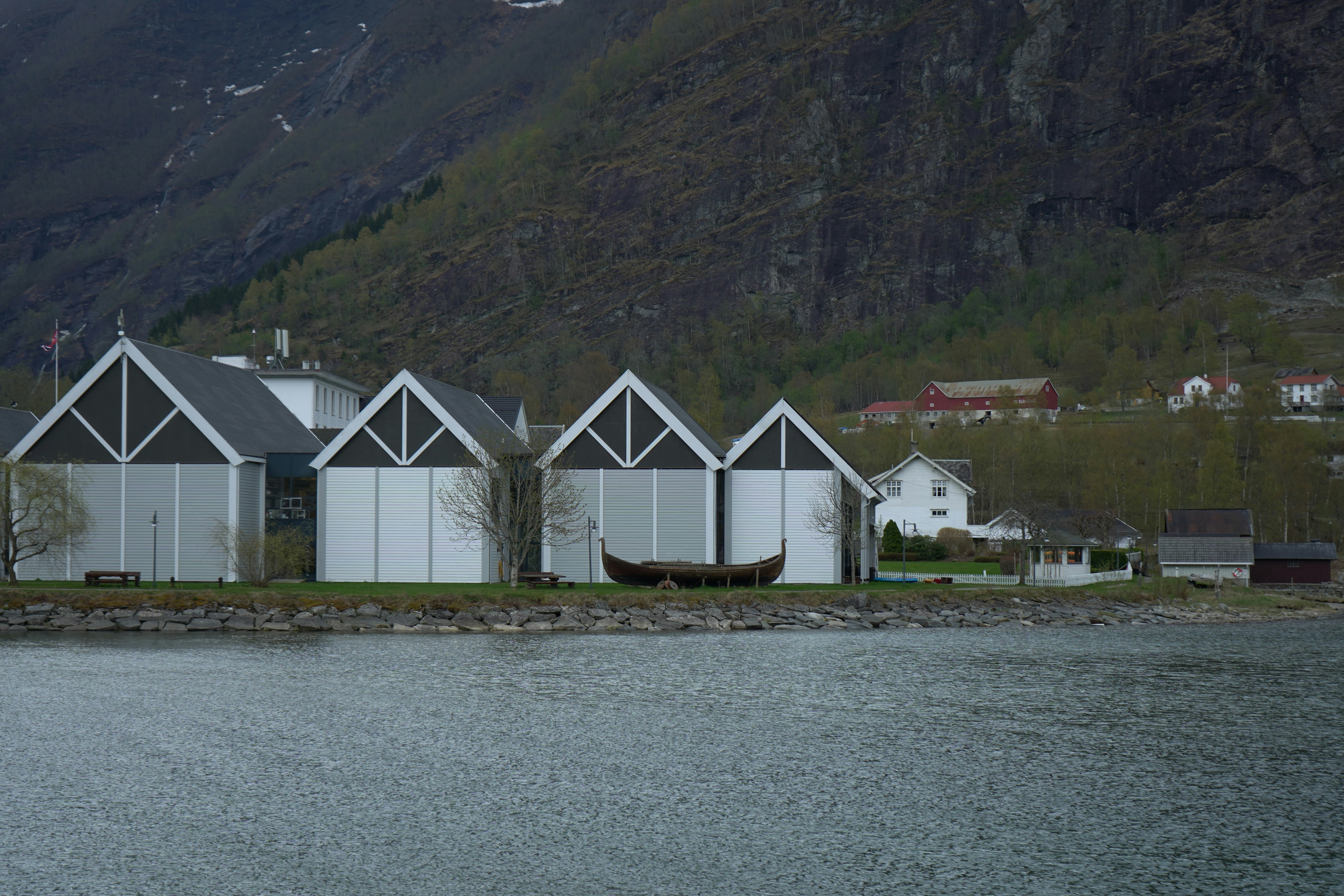 a row of white houses sitting next to a body of water