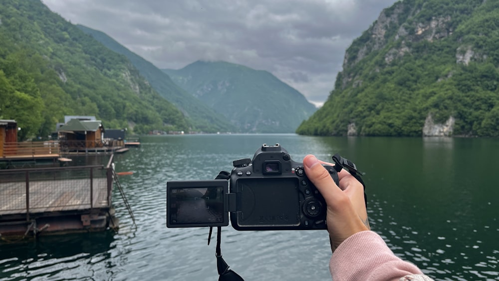 a person taking a picture of a body of water