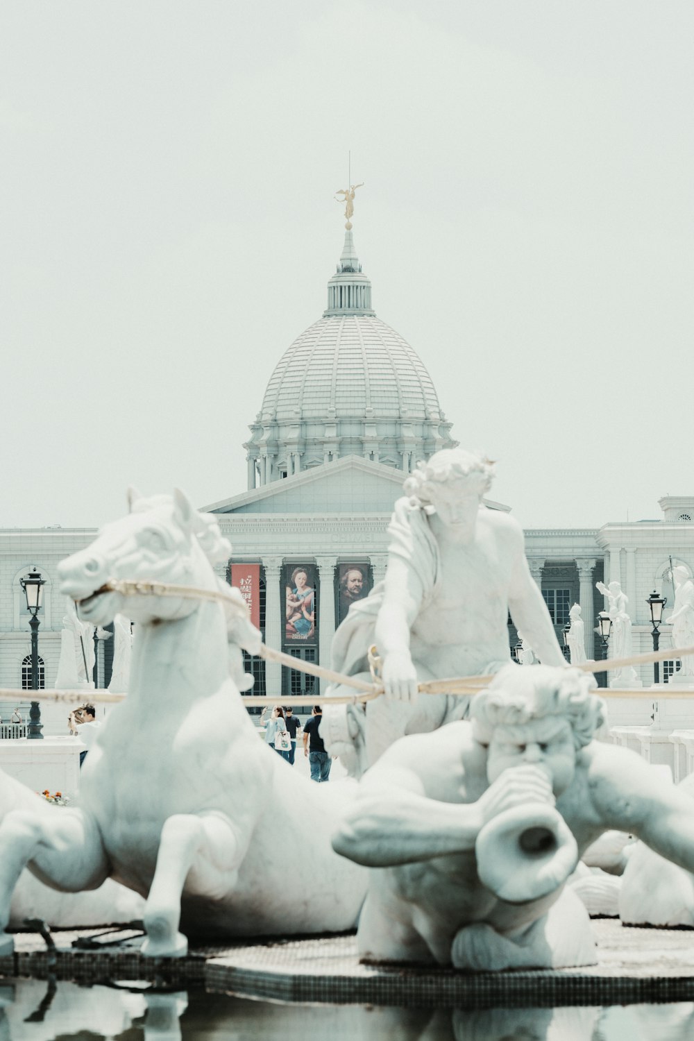 a statue of a man riding a horse in front of a building