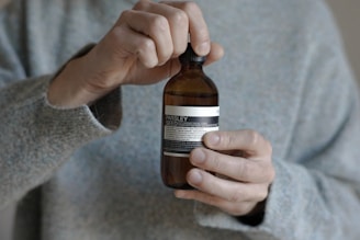 a person holding a bottle of beer in their hand