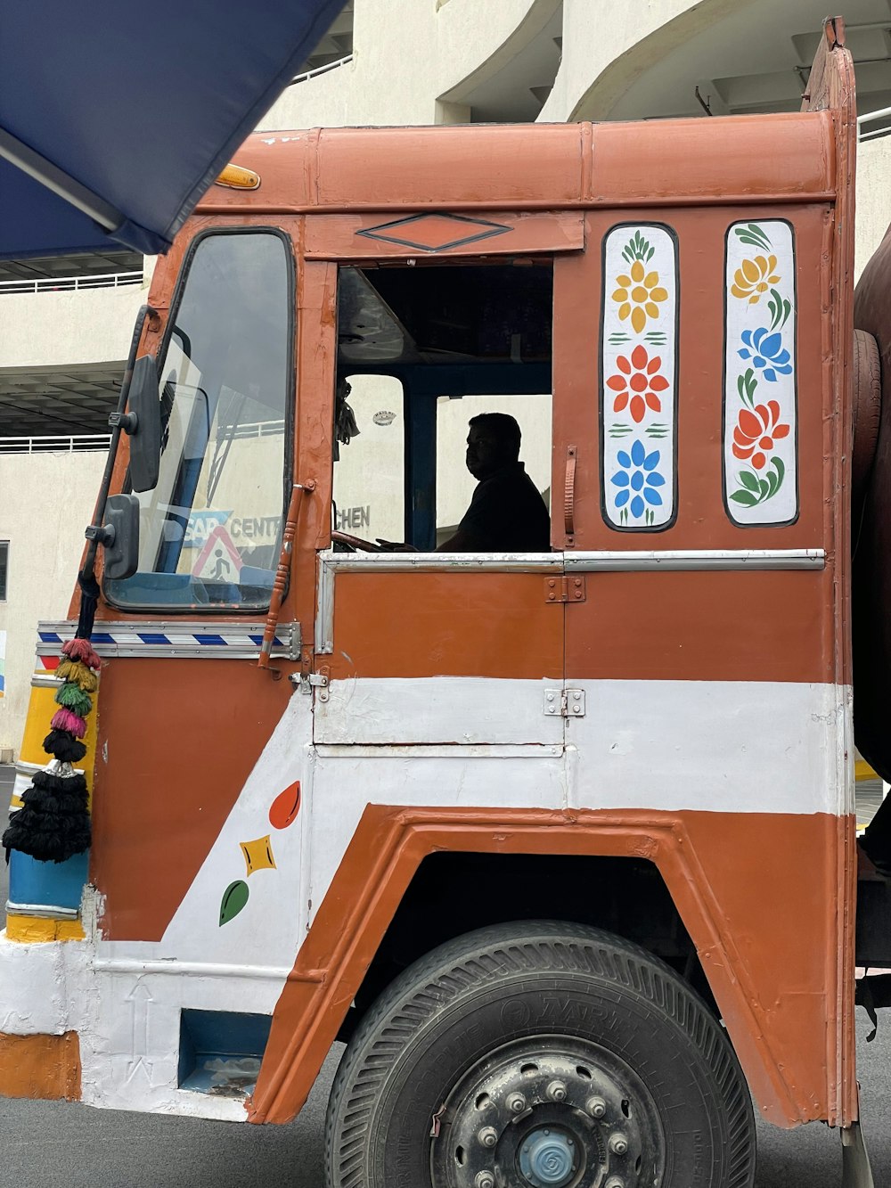 a man sitting in the driver's seat of a food truck