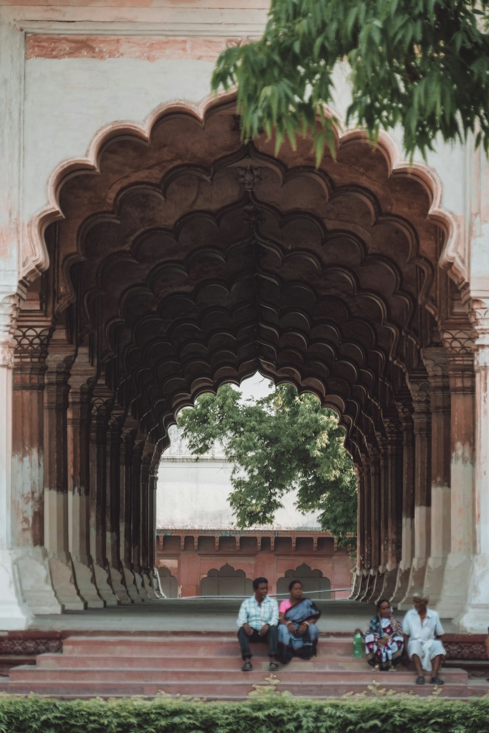 a group of people sitting under an archway
