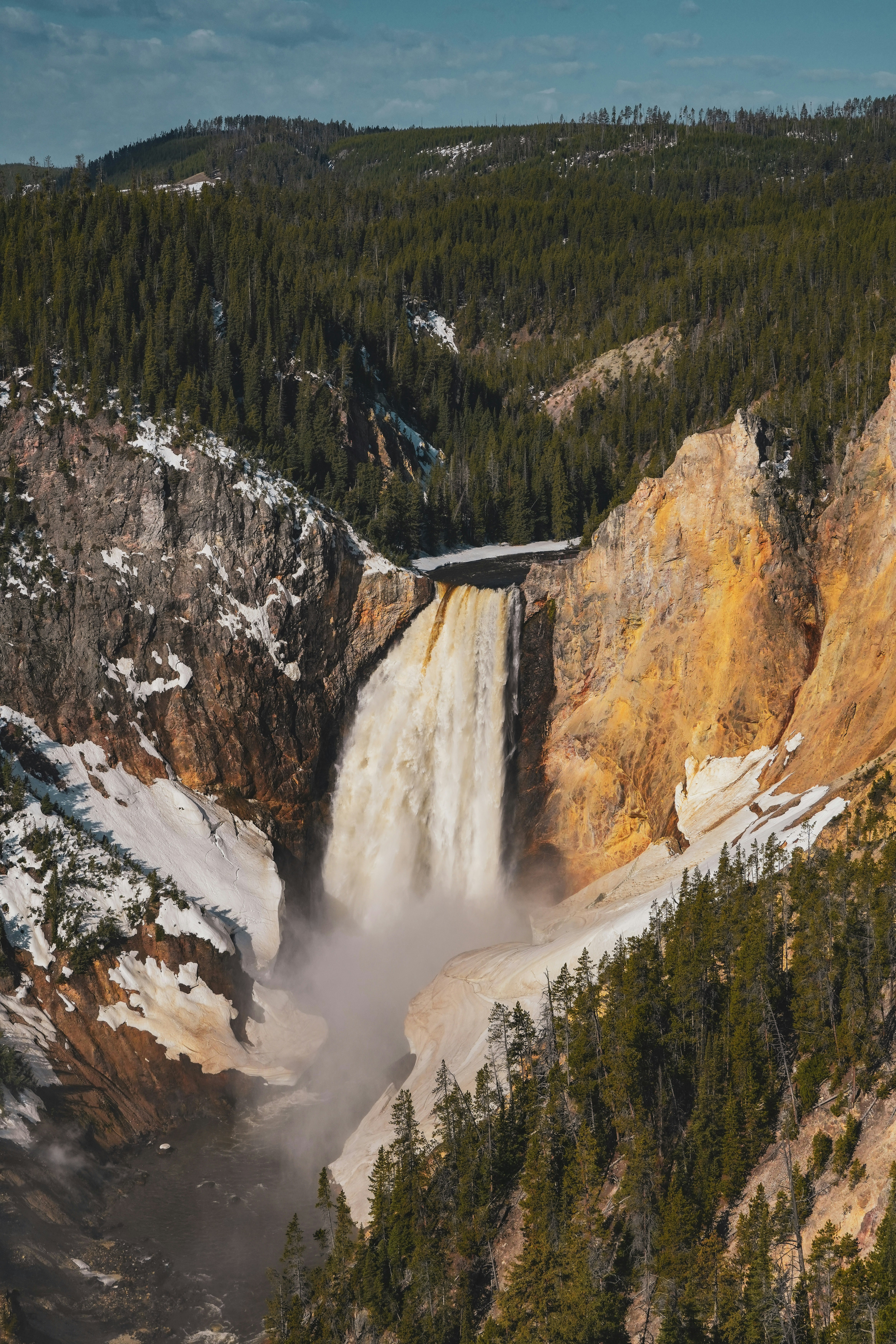 a view of a waterfall with snow on the ground