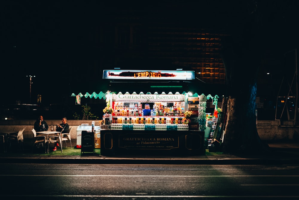 a food stand on the side of the road at night