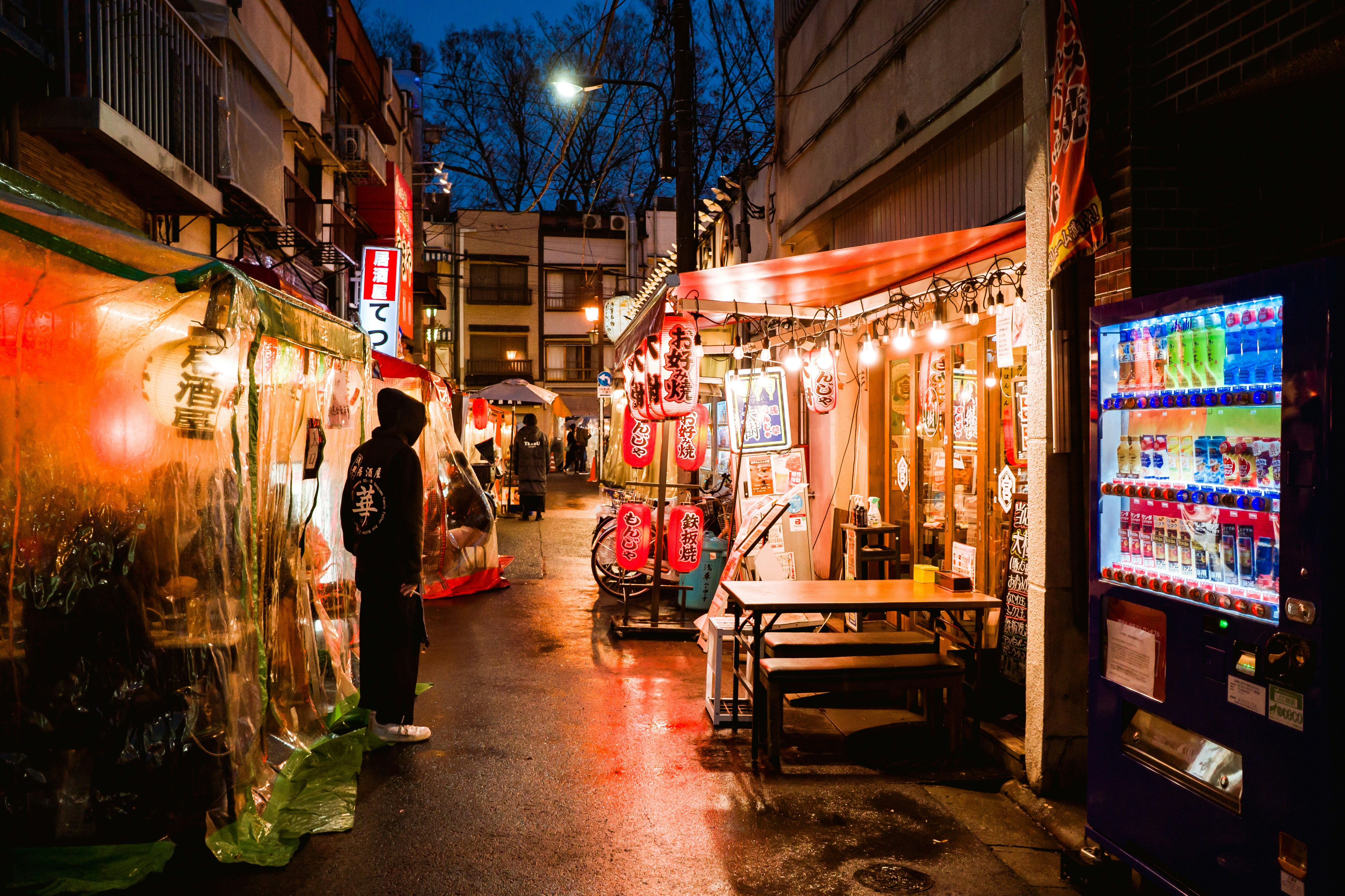 a man is standing in an alley at night