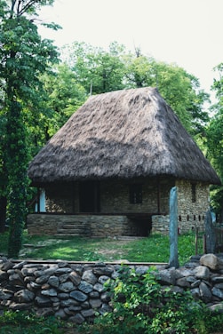 a stone house with a thatched roof