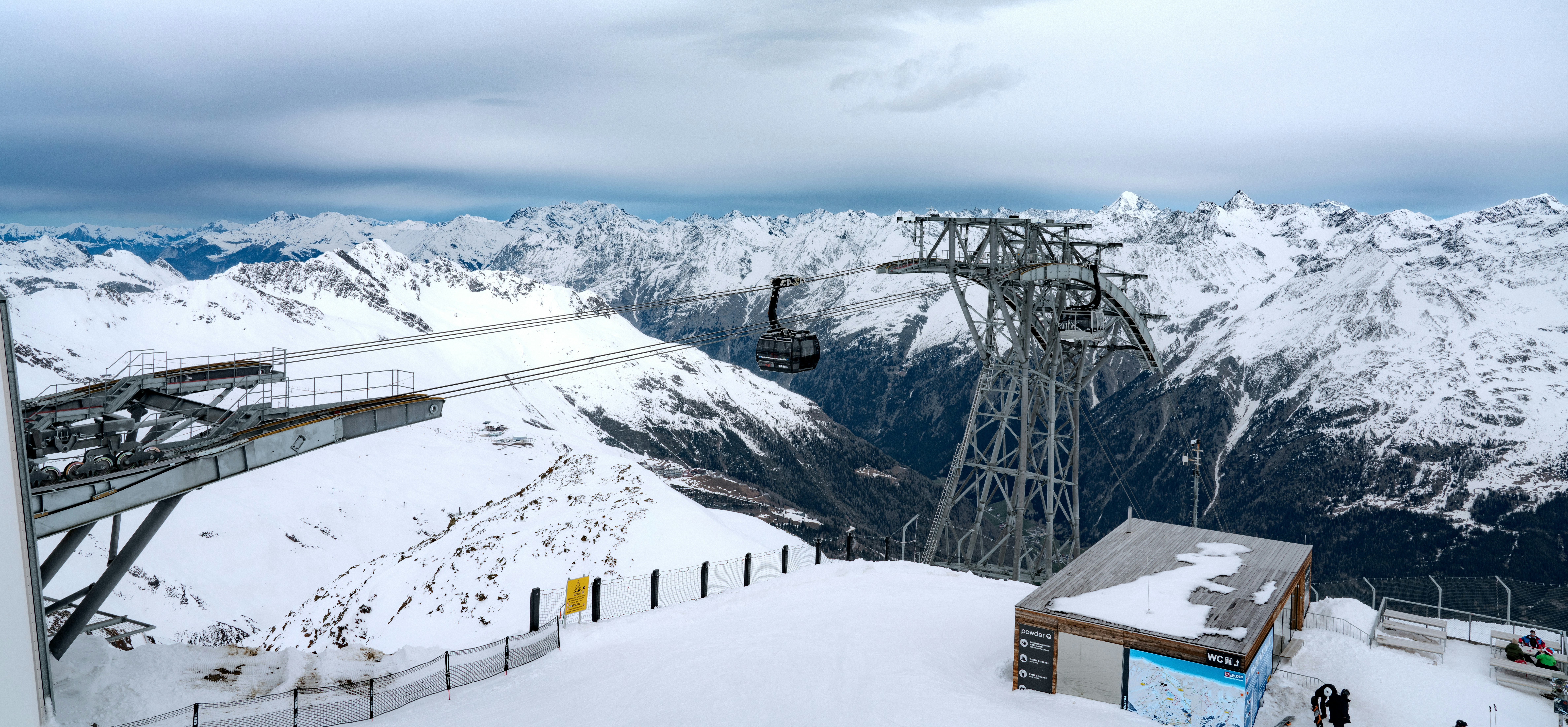Gulmarg Gondola cable car ascending snow-covered slopes with Himalayan peaks in background