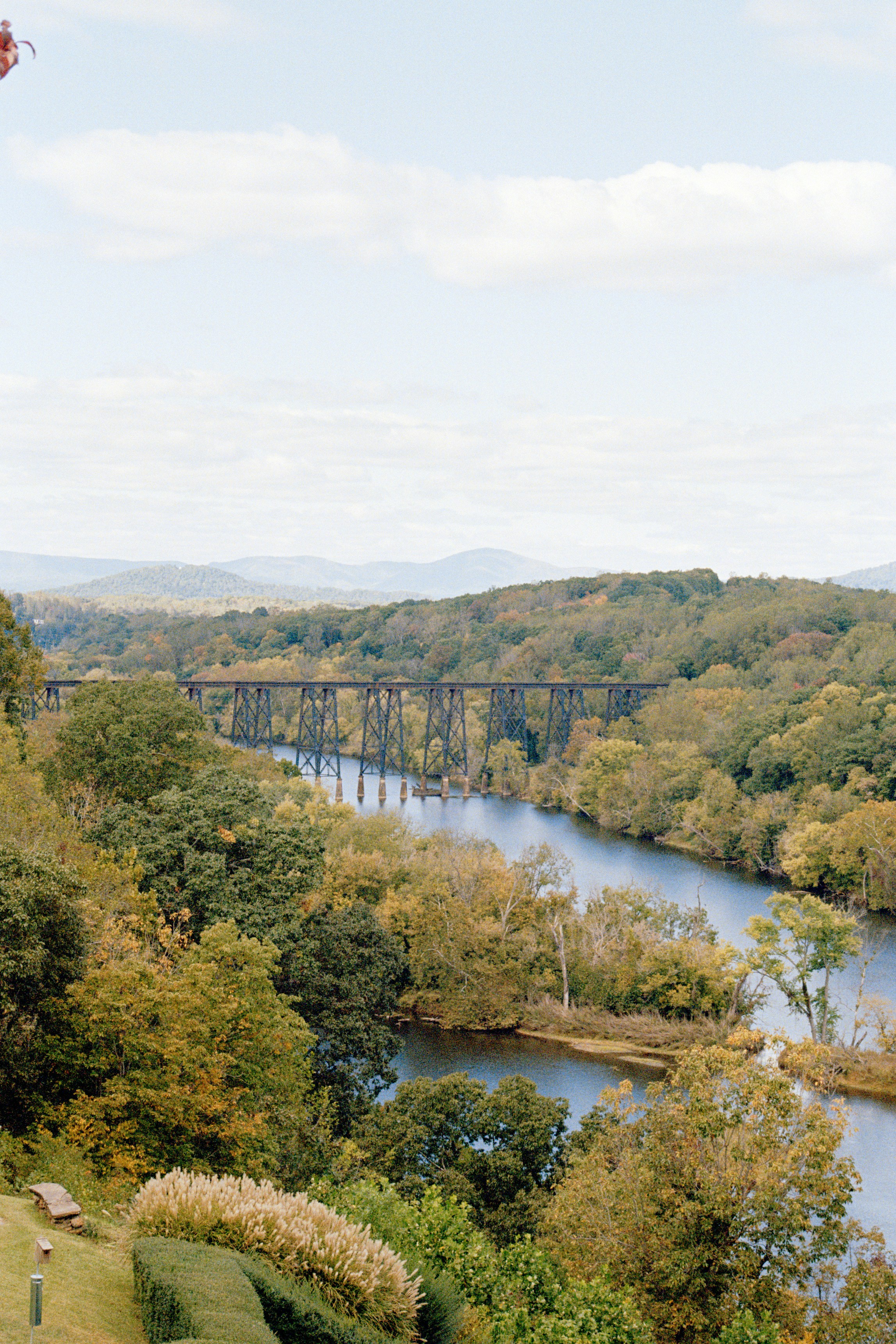 a view of a river and a bridge in the distance