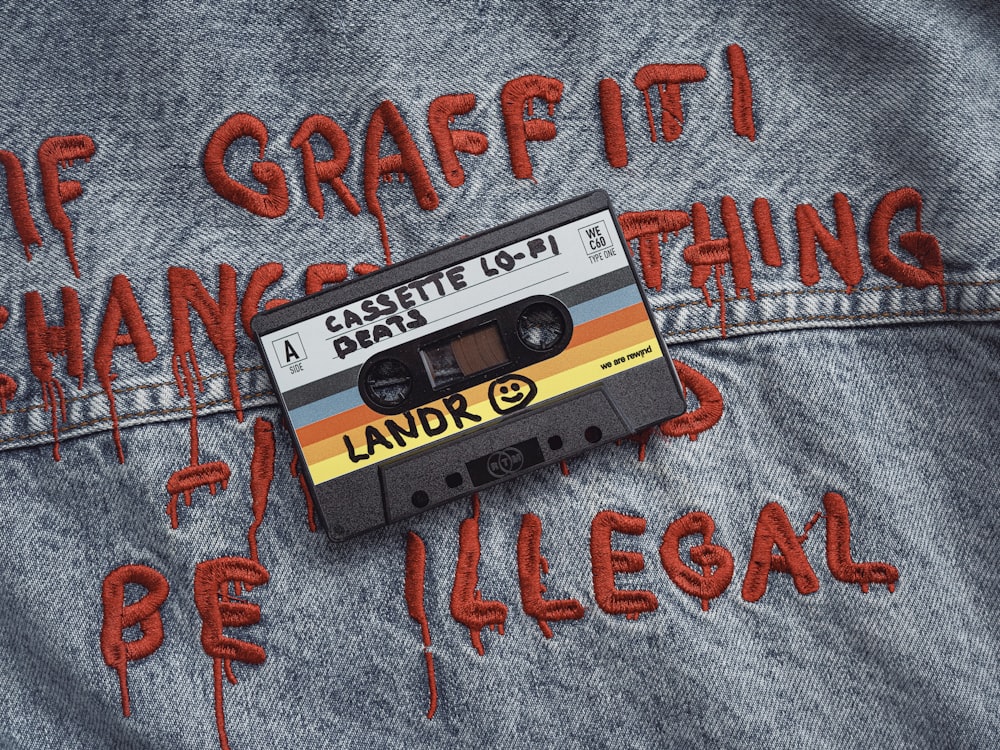 a cassette cassette with graffiti written on it