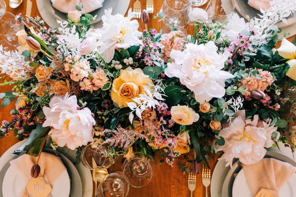 a close up of a table with plates and flowers